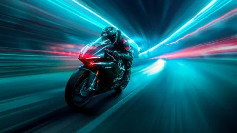MotoGP Rider Speeding on Neon-Lit Futuristic City Road