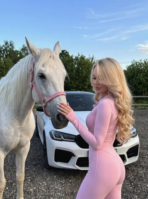 Girl Poses With Horse And BMW