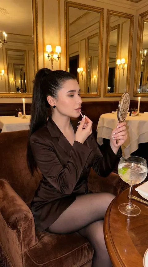Elegant Lady Applying Lip Gloss