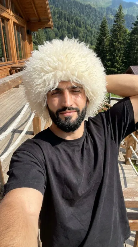 Mountain Selfie with Fluffy White Hat