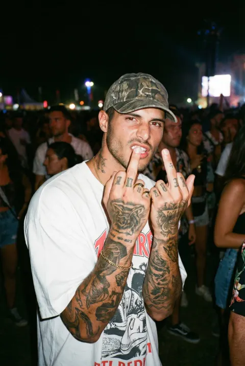 Rebel Flashing Middle Finger at Party