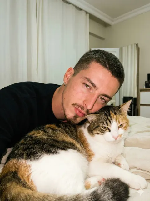 Muscular Man Nuzzling Tricolor Cat
