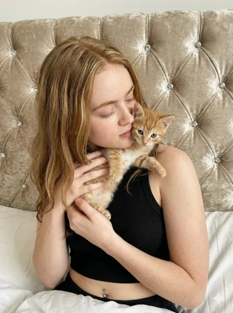 Young Woman Kissing Adorable Kitten