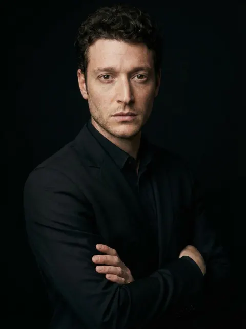 Confident Man in Black Suit