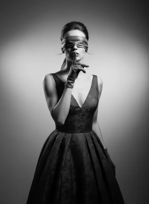 Elegant woman portrait holding finger to her lips