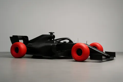 Striking visual effect of black F1 car with red tires