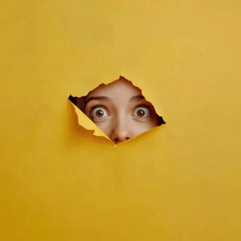 Cheerful Woman Through Yellow Paper