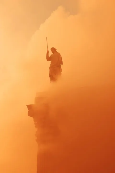 Greek Statue on Column in Orange Heat Haze City