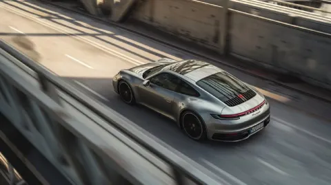 Silver Porsche 992 Driving Through Urban Tunnel From Above