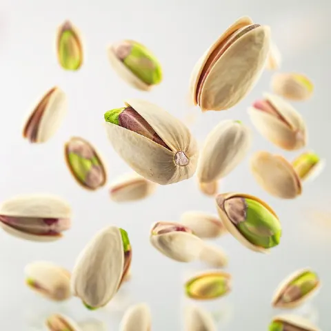 Giant Pistachios Floating on White Background