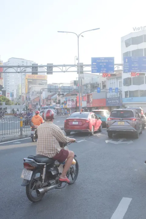 Vietnamese Riding Motorbikes in Rain