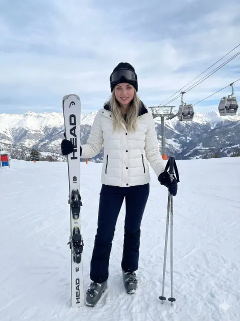 Blonde Woman Skiing On Snowy Slope