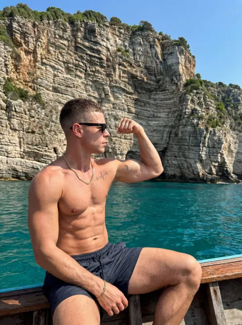 Muscular Man Boat Cliff View