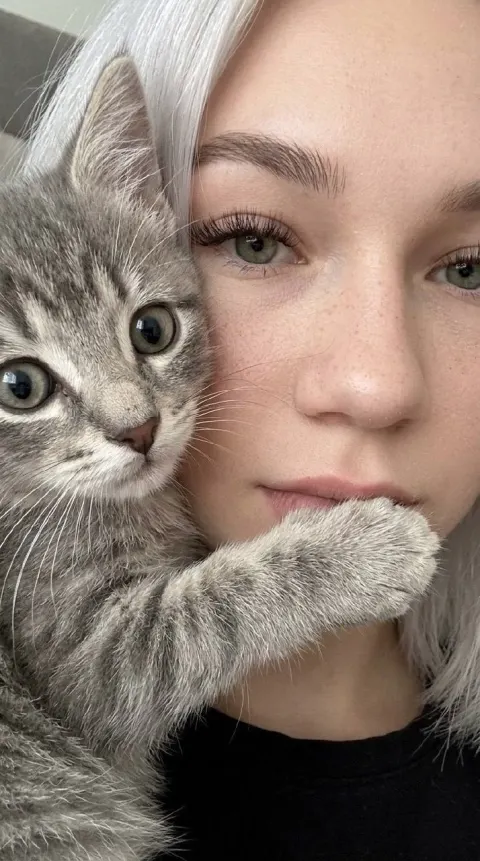 Kitten Gently Covers Girl's Lips in Close-Up Selfie