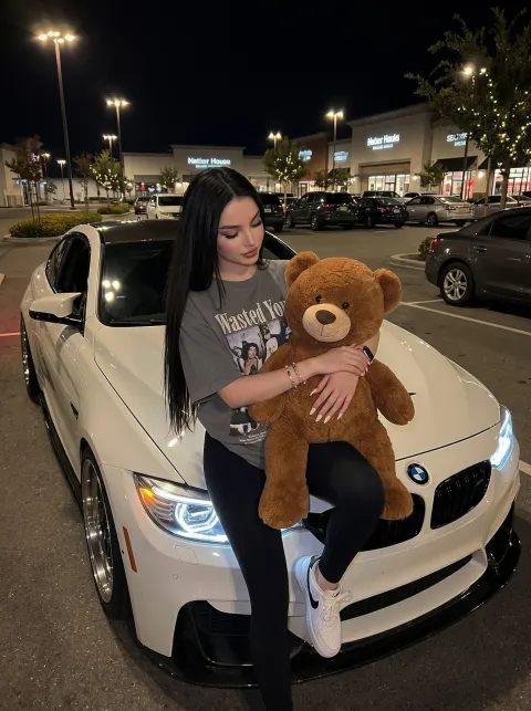 Girl Hugging Teddy Bear on Car Hood
