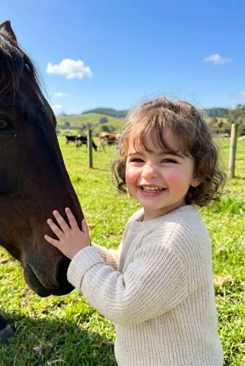 Girl's Joyful Moment with Horse