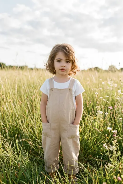 Girl Standing in Tall Grass