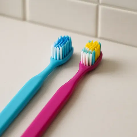 Two Vibrant Toothbrushes Resting Next