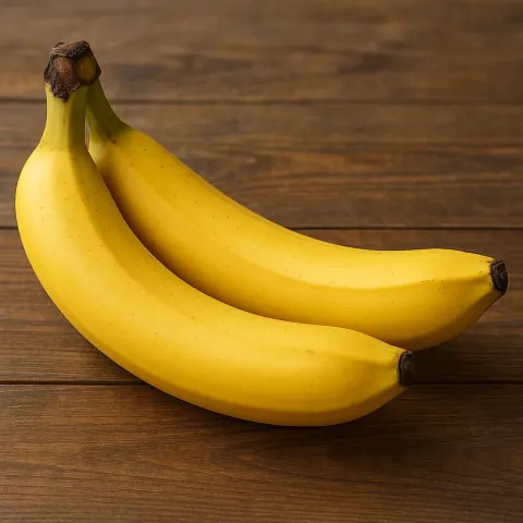 Pair of Ripe Yellow Bananas Placed on a Wooden Tabletop