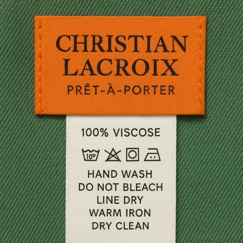 Orange Christian Lacroix Prêt-à-porter Clothing Label Sewn Onto Green Fabric