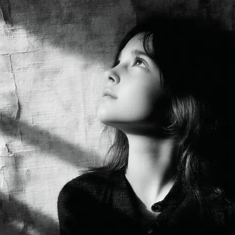 Melancholy Girl Looking Up in Grainy Monochrome