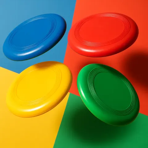 Showcasing Four Vibrant Flying Discs Placed in an Energetic