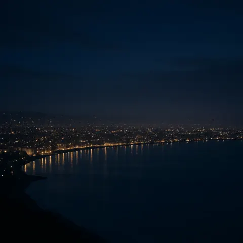 Myriad Pinpricks of Light from Distant City Buildings Stretch