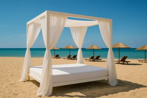 White Canopy Bed with Curtains on a Sandy Beach