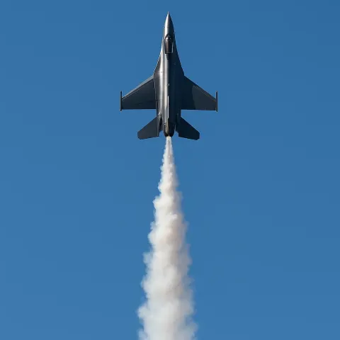 Modern Aircraft Emitting a Streak of Smoke
