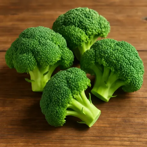 Four Lively Green Broccoli Florets Grouped Together on a Wooden