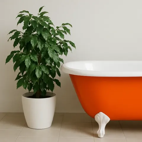 Showcasing a Bright Orange Bathtub with a White Potted Plant