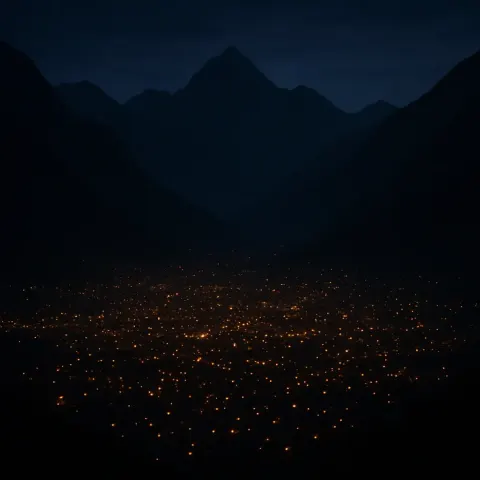 Numerous Tiny Lights from a Sprawling Settlement Twinkle
