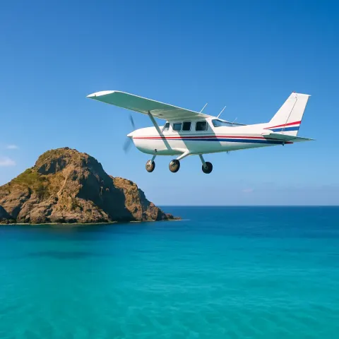 Small Airplane Flying over a Turquoise Ocean