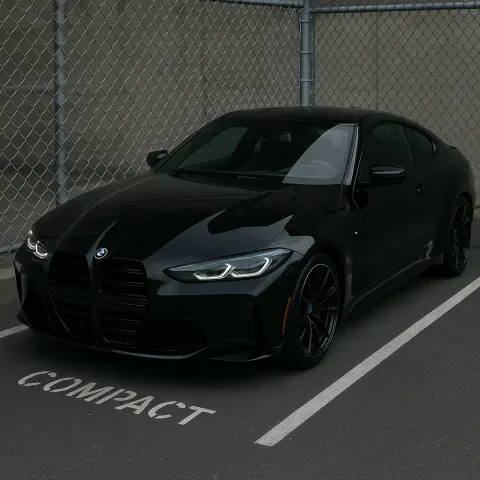Sleek Black BMW Sports Car Parked near a Chain-link Fence