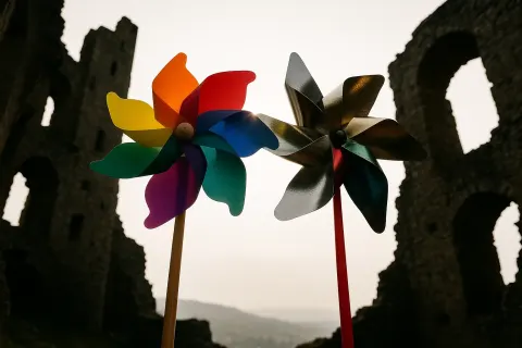 Two Distinct Pinwheels—one Showcasing Vibrant Rainbow Spectrum Vanes