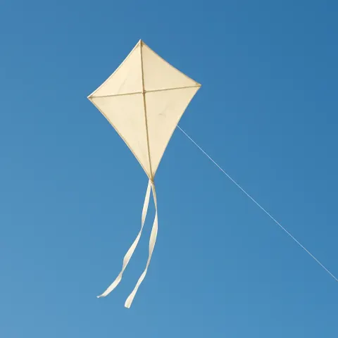 Kite with a Pale Cream Hue Soaring Through a Cloudless