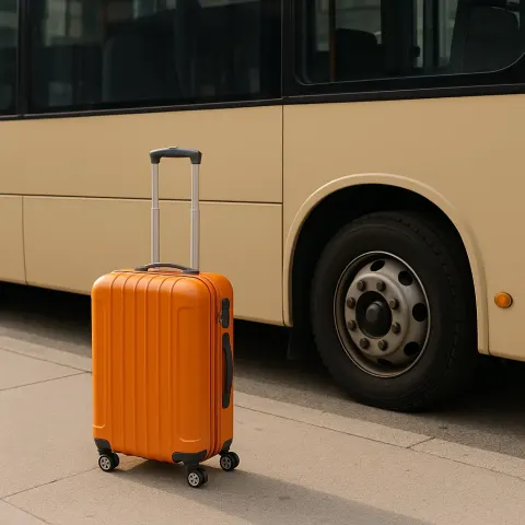Orange Suitcase Placed Beside a Bus