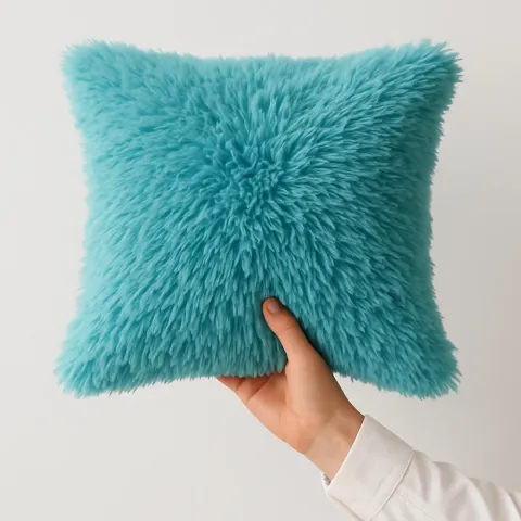 Person Wearing a White Sleeve Holds a Fluffy Turquoise Pillow