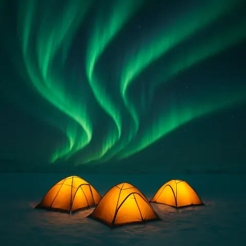 Small Cluster of Illuminated Tents Rests on a Snow-covered Plain