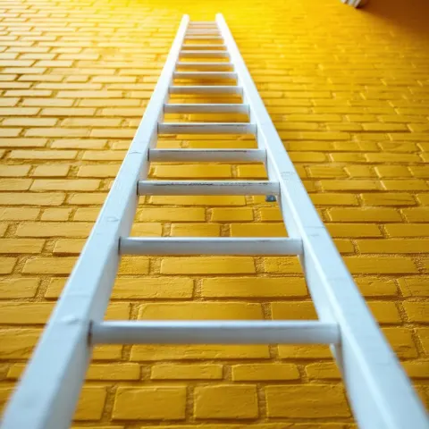 White Ladder Against a Yellow Brick Wall
