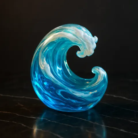 Glass-blown "🌊" Sits Atop a Sleek Black Marble Surface