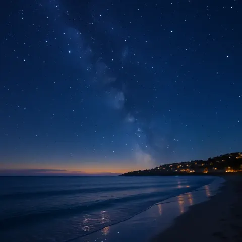 Beach Features a Serene Sea Beneath a Deep Navy Sky