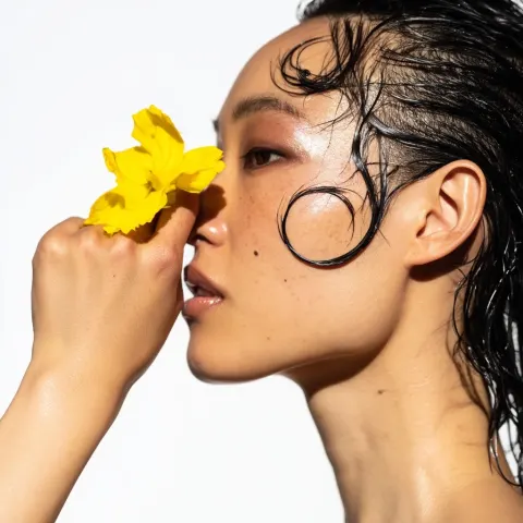 High-fashion beauty editorial close-up profile of an Asian woman, side view