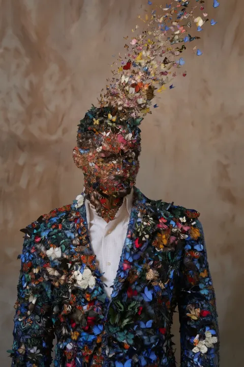 A stylish, mature jacket and suit, with butterflies gradually transforming into a human body and hea