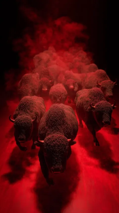 Massive herd of crimson bison seen from above, charging through the dusty plains of the Don