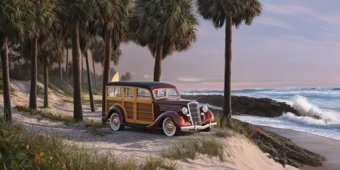A 1935 woody station wagon sitting on a sand dune overlooking the beach on the east coast of florida