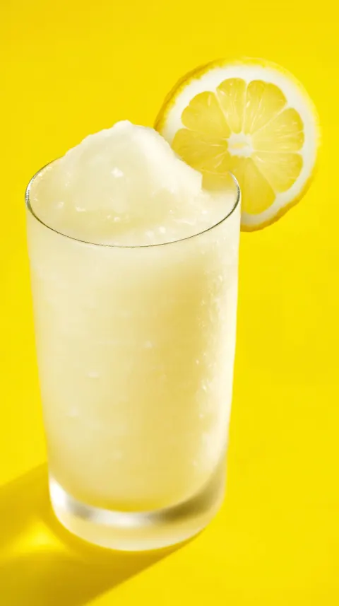 Close up three quarter top down food photography shot of a delicious looking frozen lemonade garnish