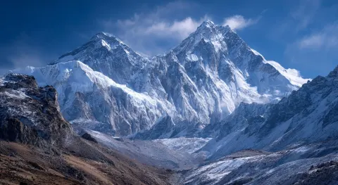A majestic view of mount everest, snow-covered peaks against the blue sky