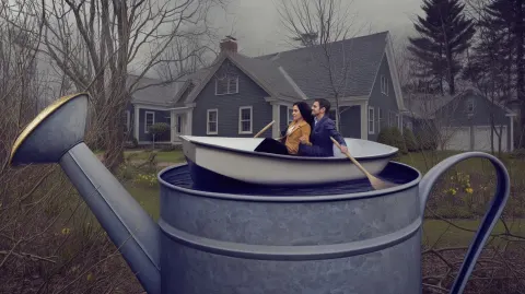 A realistic scene taking place of a married couple in a rowboat inside a full garden watering can