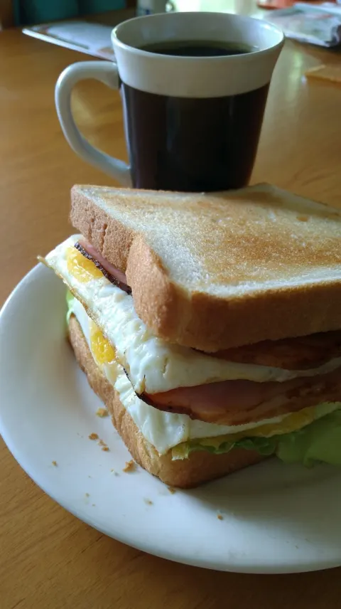 Japanese breakfast sandwich and coffee, lightly toasted sandwich with visible egg, ham